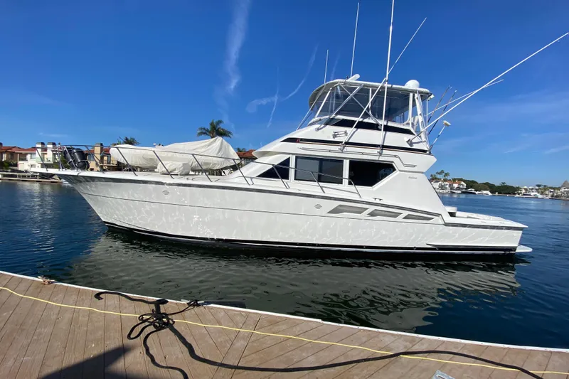 Slide: The Image of 1995 Hatteras 50 Convertible Sportfish yacht docked in sunny marina setting. - 11