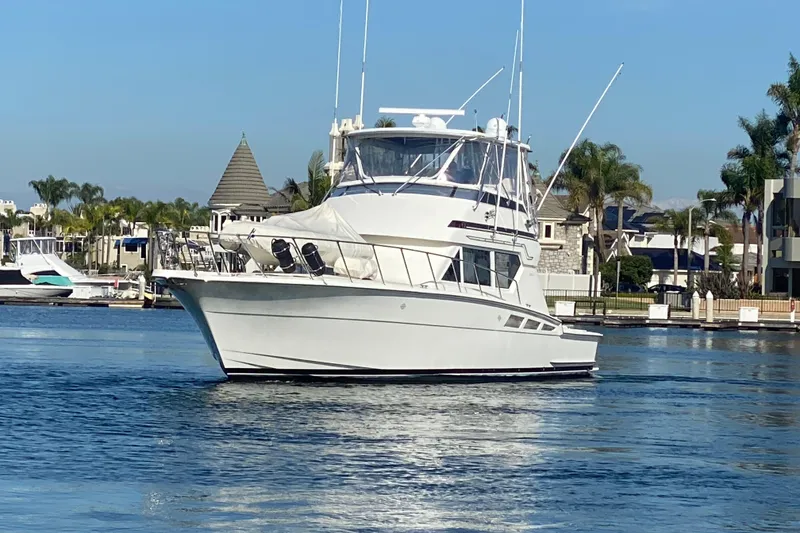 Slide: The Image of 1995 Hatteras 50 Convertible Sportfish yacht cruising in a scenic marina. - 14