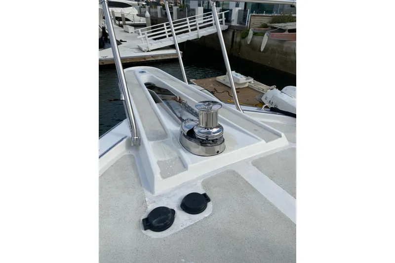 Slide: The Image of 1995 Hatteras 50 Convertible Sportfish boat deck with winch and railing. - 28