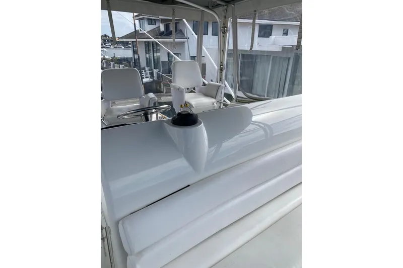 Slide: The Image of 1995 Hatteras 50 Convertible Sportfish boat interior with white seating and steering area. - 32