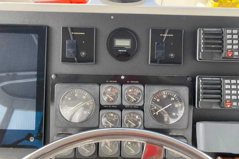 Slide: The Image of Control panel of a 1995 Hatteras 50 Convertible Sportfish with gauges and navigation equipment. - 34