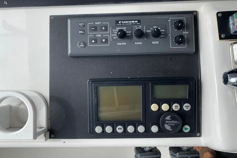 Slide: The Image of Control panel of a 1995 Hatteras 50 Convertible Sportfish with navigation equipment. - 36