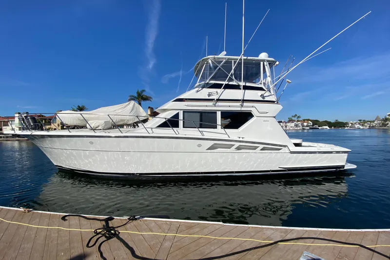 Slide: The Image of 1995 Hatteras 50 Convertible Sportfish yacht docked on a sunny day. - 4