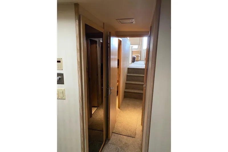 Slide: The Image of Interior hallway of 1995 Hatteras 50 Convertible Sportfish yacht with carpeted stairs. - 42