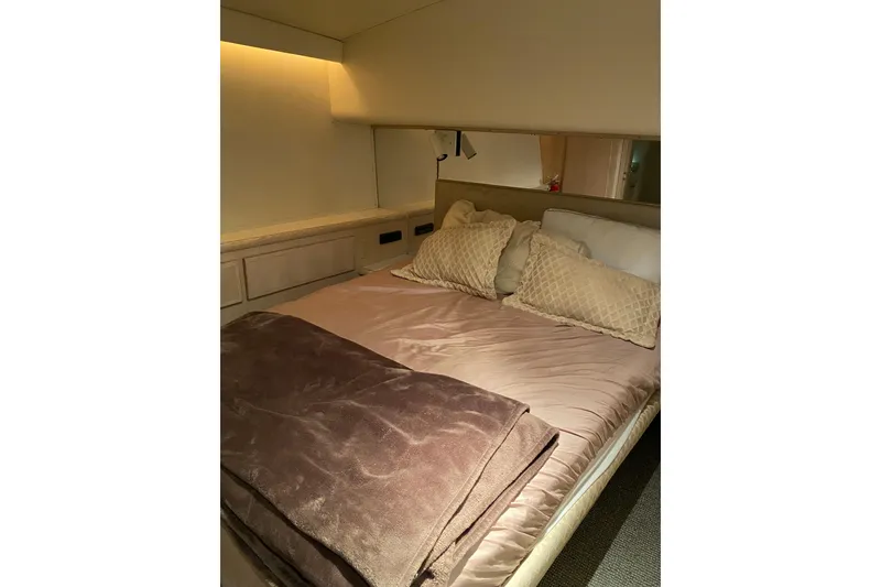 Slide: The Image of Cozy bedroom interior of 1995 Hatteras 50 Convertible Sportfish yacht with plush bedding. - 45