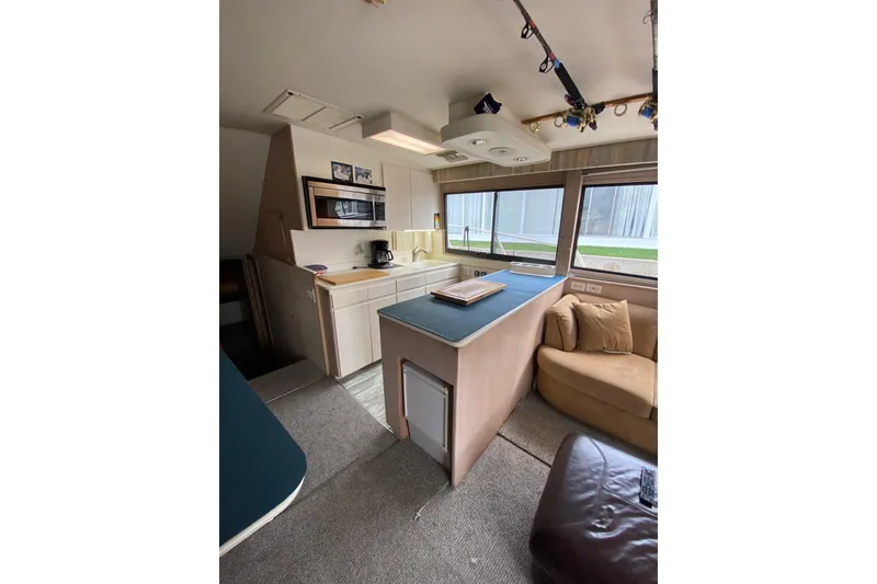 Slide: The Image of Interior of 1995 Hatteras 50 Convertible Sportfish yacht with kitchen and seating area. - 47