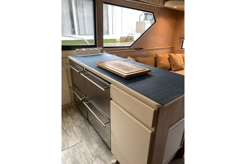 Slide: The Image of Interior of 1995 Hatteras 50 Convertible Sportfish with modern kitchen and seating area. - 52