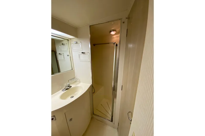 Slide: The Image of Bathroom interior of 1995 Hatteras 50 Convertible Sportfish yacht, featuring sink and shower. - 55