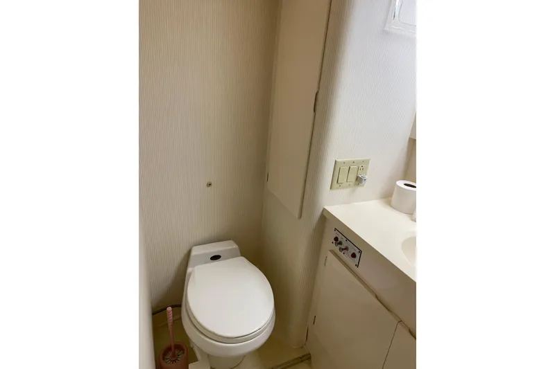 Slide: The Image of Bathroom interior of 1995 Hatteras 50 Convertible Sportfish yacht, featuring toilet and sink. - 59