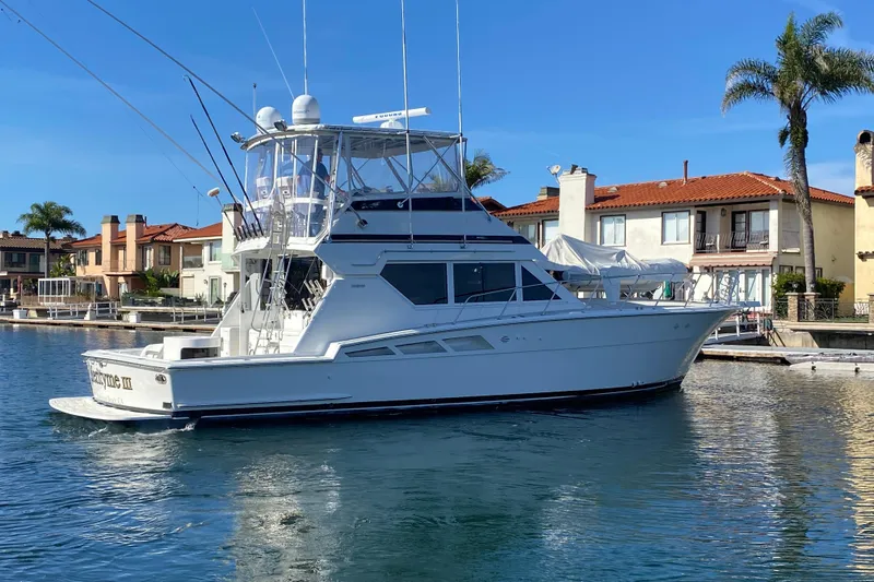 Slide: The Image of 1995 Hatteras 50 Convertible Sportfish yacht docked in a sunny marina. - 6