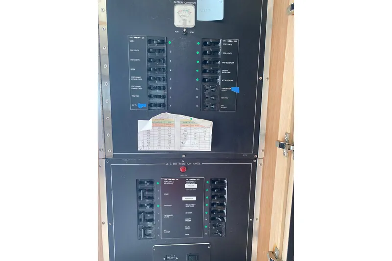 Slide: The Image of Electrical panel of 1995 Hatteras 50 Convertible Sportfish boat, showing circuit breakers and controls. - 62