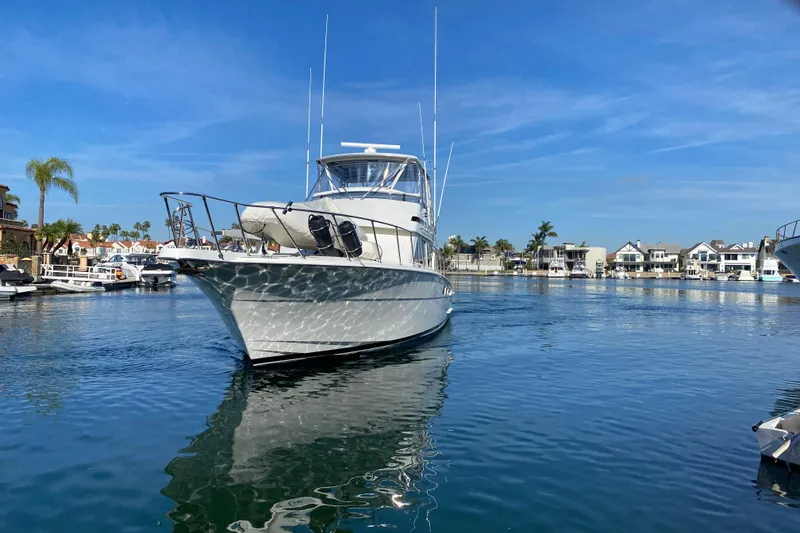 Slide: The Image of 1995 Hatteras 50 Convertible Sportfish yacht in a sunny marina setting. - 8