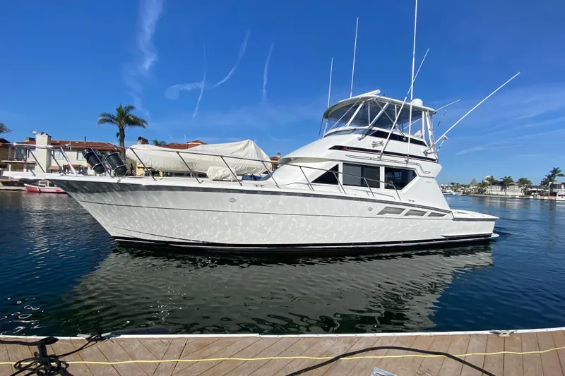 Slide: The Image of 1995 Hatteras 50 Convertible Sportfish yacht docked in sunny marina. - 10
