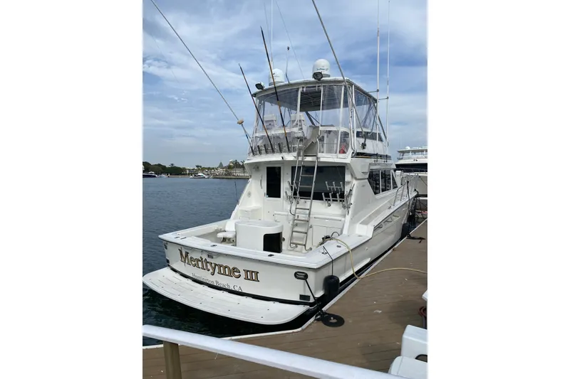 Slide: The Image of 1995 Hatteras 50 Convertible Sportfish boat docked, rear view with clear skies. - 17