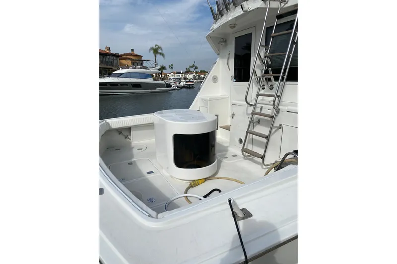 Slide: The Image of 1995 Hatteras 50 Convertible Sportfish yacht deck with ladder and fishing equipment. - 18