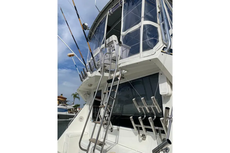 Slide: The Image of 1995 Hatteras 50 Convertible Sportfish boat with fishing rod holders and ladder. - 20