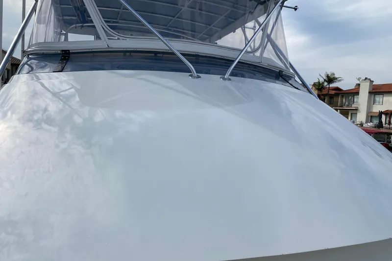 Slide: The Image of 1995 Hatteras 50 Convertible Sportfish boat with sleek white exterior and clear canopy. - 21