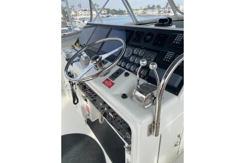 Slide: The Image of Helm of 1995 Hatteras 50 Convertible Sportfish with steering wheel and control panel. - 31