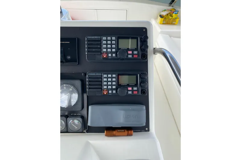 Slide: The Image of Control panel of 1995 Hatteras 50 Convertible Sportfish with communication devices and gauges. - 37