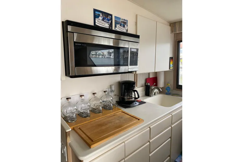 Slide: The Image of Kitchen area of 1995 Hatteras 50 Convertible Sportfish with microwave and sink. - 40