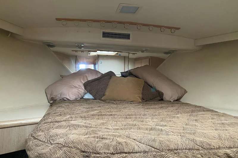 Slide: The Image of Interior cabin of 1995 Hatteras 50 Convertible Sportfish with bed and pillows. - 41