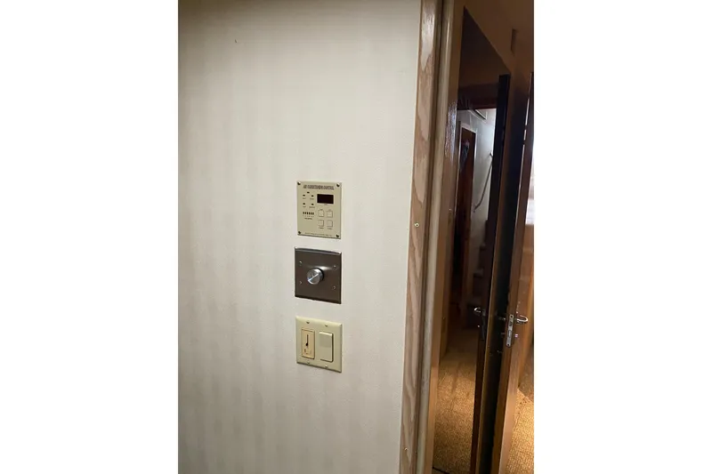 Slide: The Image of Interior view of 1995 Hatteras 50 Convertible Sportfish with control panels on wall. - 44