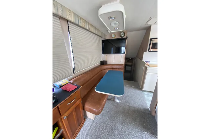 Slide: The Image of Interior of 1995 Hatteras 50 Convertible Sportfish with dining area and TV. - 48