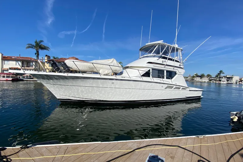 Slide: The Image of 1995 Hatteras 50 Convertible Sportfish yacht docked in a sunny marina. - 5