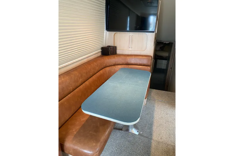 Slide: The Image of Interior of 1995 Hatteras 50 Convertible Sportfish with leather seating and dining table. - 53