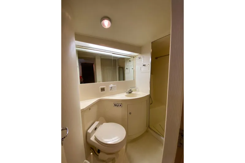 Slide: The Image of Bathroom interior of 1995 Hatteras 50 Convertible Sportfish yacht, featuring toilet and sink. - 56