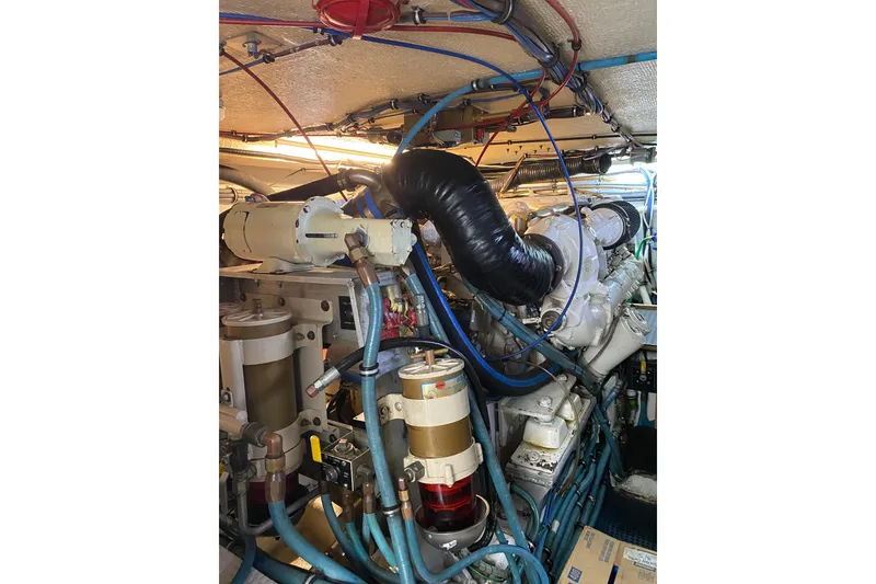 Slide: The Image of Engine room of 1995 Hatteras 50 Convertible Sportfish with complex machinery and wiring. - 65