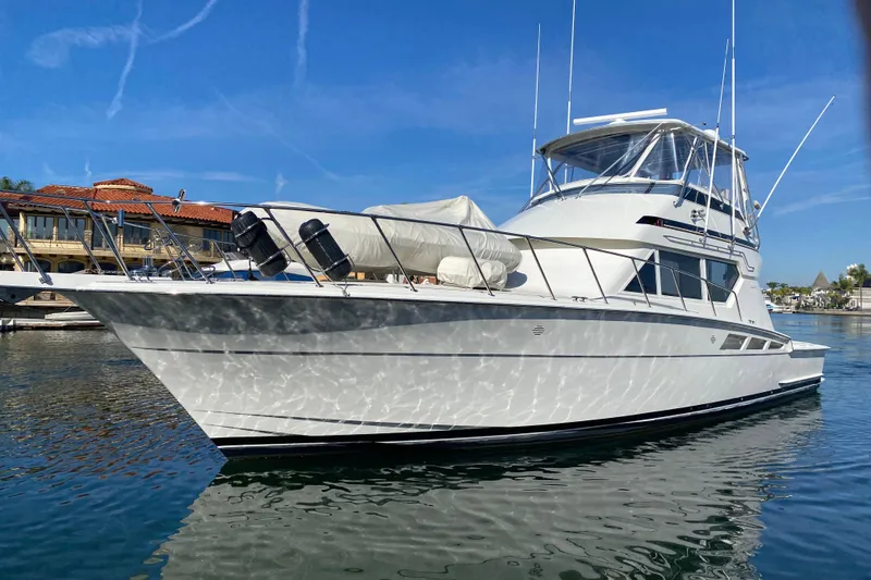 Slide: The Image of 1995 Hatteras 50 Convertible Sportfish yacht docked in sunny marina. - 9