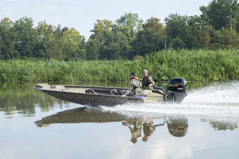 Slide: The Image of Manufacturer Provided Image: 2026 Xpress X18DB boat speeding on a calm river with two passengers. - 11