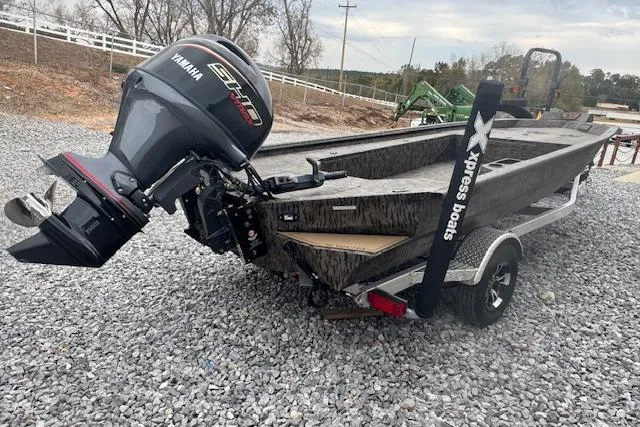 Slide: The Image of 2026 Xpress X18DB boat with Yamaha engine on gravel lot. - 12