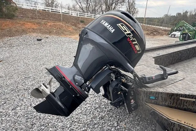 Slide: The Image of 2026 Xpress X18DB boat with Yamaha SHO outboard motor on gravel surface. - 8