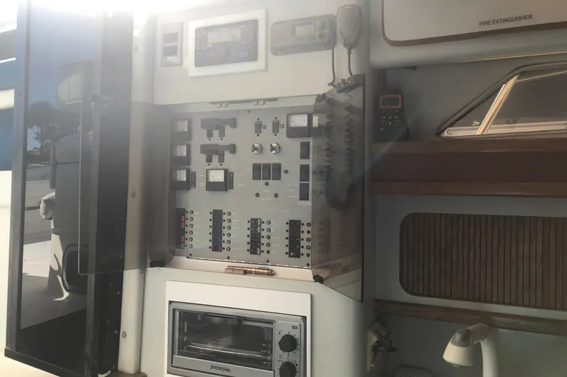 Slide: The Image of 1990 Sea Ray 440 Express control panel with various switches and gauges. - 11