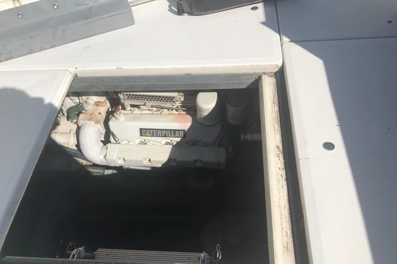 Slide: The Image of Engine compartment of 1990 Sea Ray 440 Express with visible Caterpillar engine. - 27