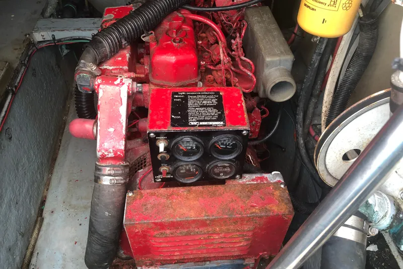 Slide: The Image of Engine compartment of a 1990 Sea Ray 440 Express, featuring a red generator. - 29