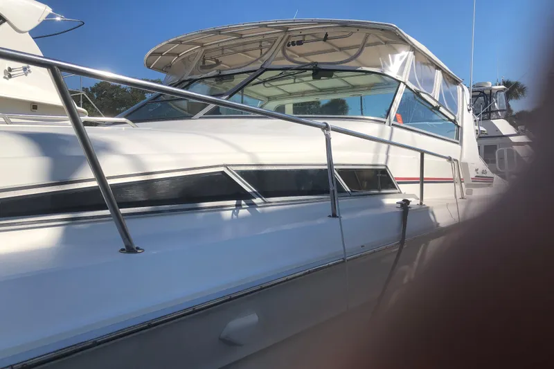 Slide: The Image of 1990 Sea Ray 440 Express yacht with sleek design and white exterior. - 6