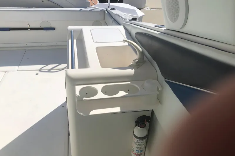 Slide: The Image of 1990 Sea Ray 440 Express boat interior with sink and fire extinguisher. - 8