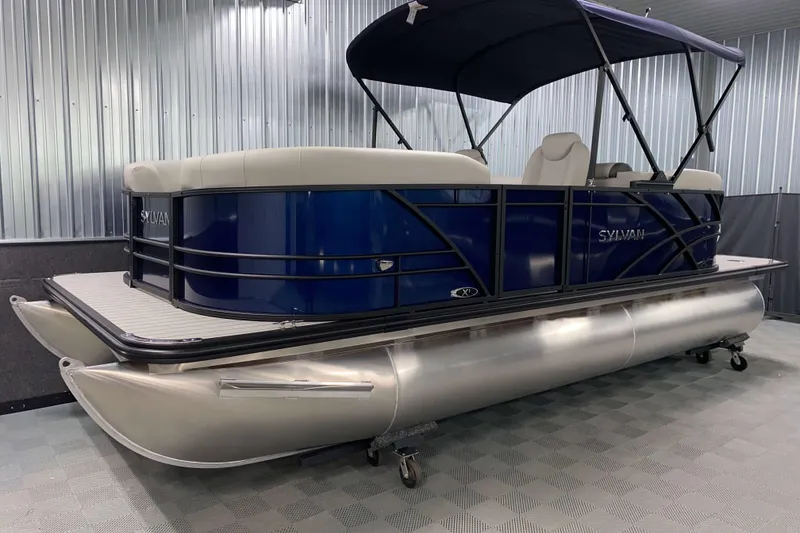 The Image of 2026 Sylvan Mirage 8520 LZ pontoon boat in showroom, featuring sleek design and canopy. - 1