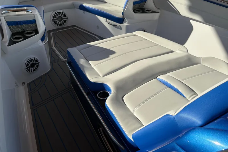Slide: The Image of 2023 Nor-Tech 390 Sport Center Console interior with blue and white seating and cup holders. - 11