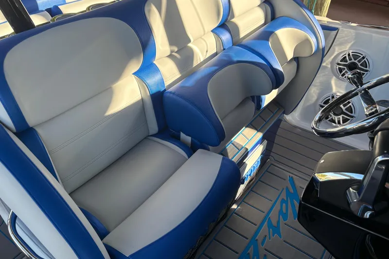 Slide: The Image of 2023 Nor-Tech 390 Sport Center Console interior with blue and white seating and steering wheel. - 12