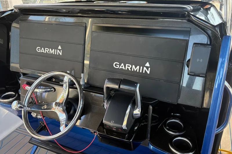 Slide: The Image of 2023 Nor-Tech 390 Sport Center Console dashboard with dual Garmin displays and steering wheel. - 14