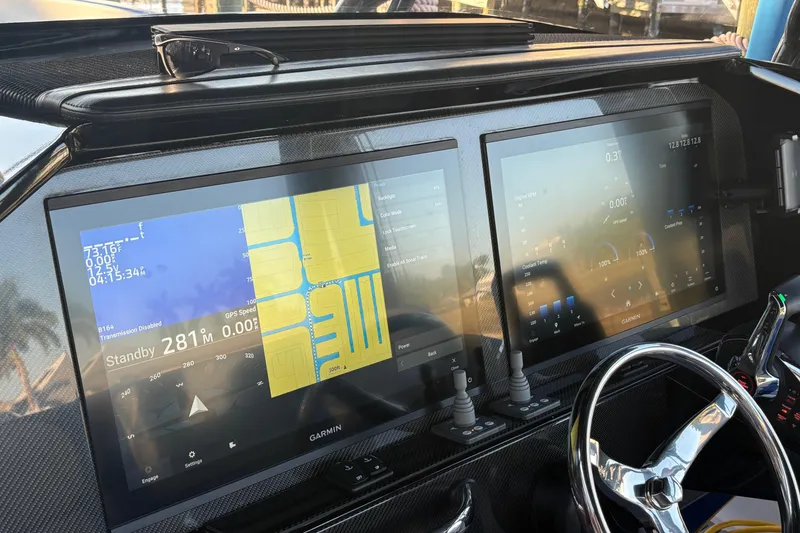 Slide: The Image of 2023 Nor-Tech 390 Sport Center Console dashboard with dual Garmin displays and steering wheel. - 15