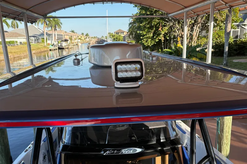Slide: The Image of 2023 Nor-Tech 390 Sport Center Console boat with sleek roof and LED light. - 17