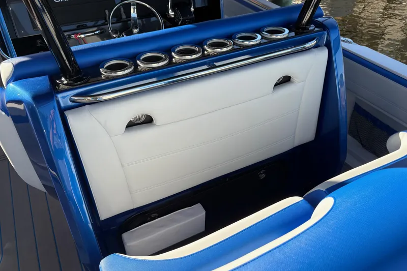 Slide: The Image of 2023 Nor-Tech 390 Sport Center Console with blue and white seating and cup holders. - 18