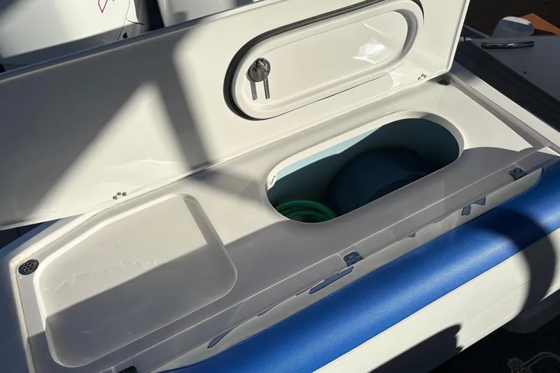 Slide: The Image of Open storage compartment on 2023 Nor-Tech 390 Sport Center Console boat. - 21