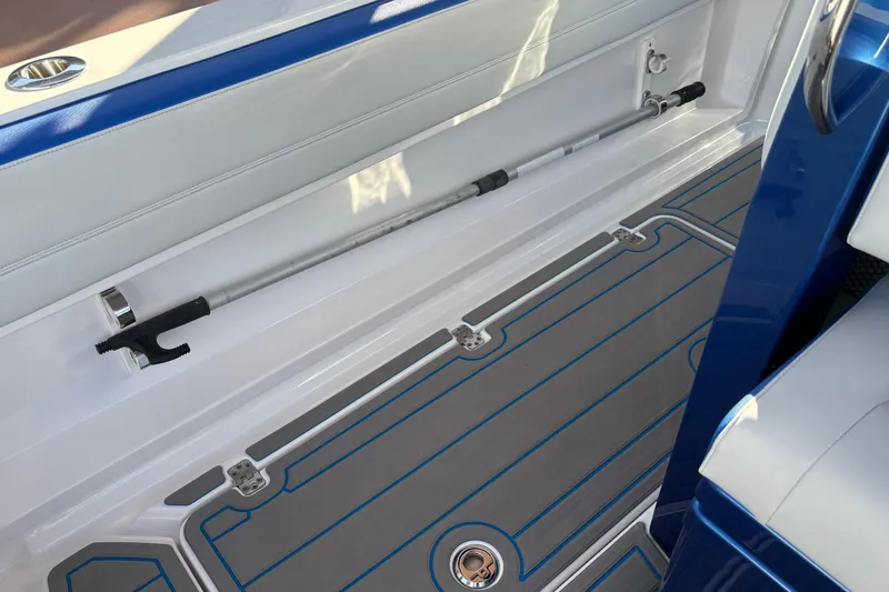 Slide: The Image of 2023 Nor-Tech 390 Sport Center Console interior with sleek blue and gray design details. - 25