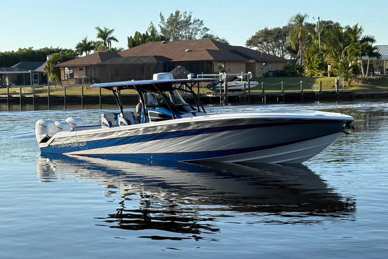 Slide: The Image of 2023 Nor-Tech 390 Sport Center Console boat on calm water near residential area. - 4
